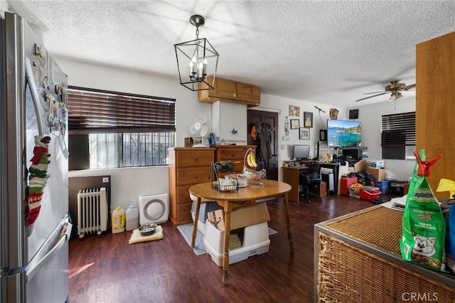 1165 E 24th St, Los Angeles, CA 90011 - dining space featuring radiator heating unit, a textured ceiling, wood finished floors, a ceiling fan, and a chandelier