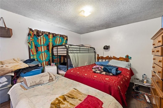 1165 E 24th St, Los Angeles, CA 90011 - bedroom featuring a textured ceiling and wood finished floors