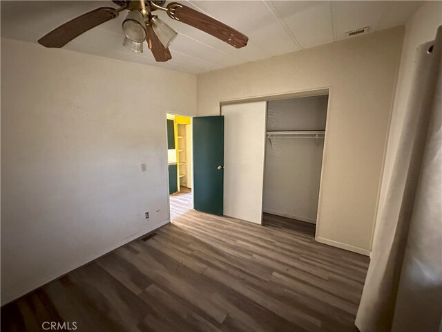 7677 Bedouin Ave Unit 29, Palms, CA 92277 - unfurnished bedroom with wood finished floors, a closet, ceiling fan, and baseboards