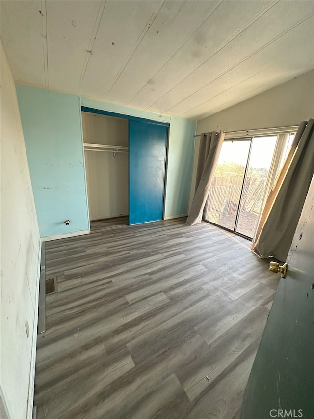 7677 Bedouin Ave Unit 29, Palms, CA 92277 - unfurnished bedroom featuring access to exterior, wood finished floors, and a closet
