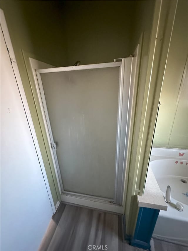 7677 Bedouin Ave Unit 29, Palms, CA 92277 - bathroom featuring a stall shower and wood finished floors