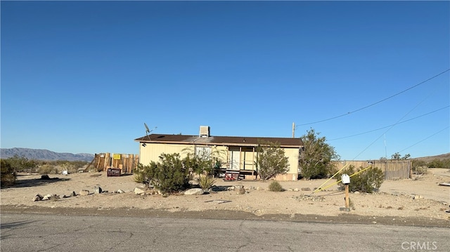 7677 Bedouin Ave Unit 29, Palms, CA 92277 - manufactured / mobile home with fence, a mountain view, and a chimney