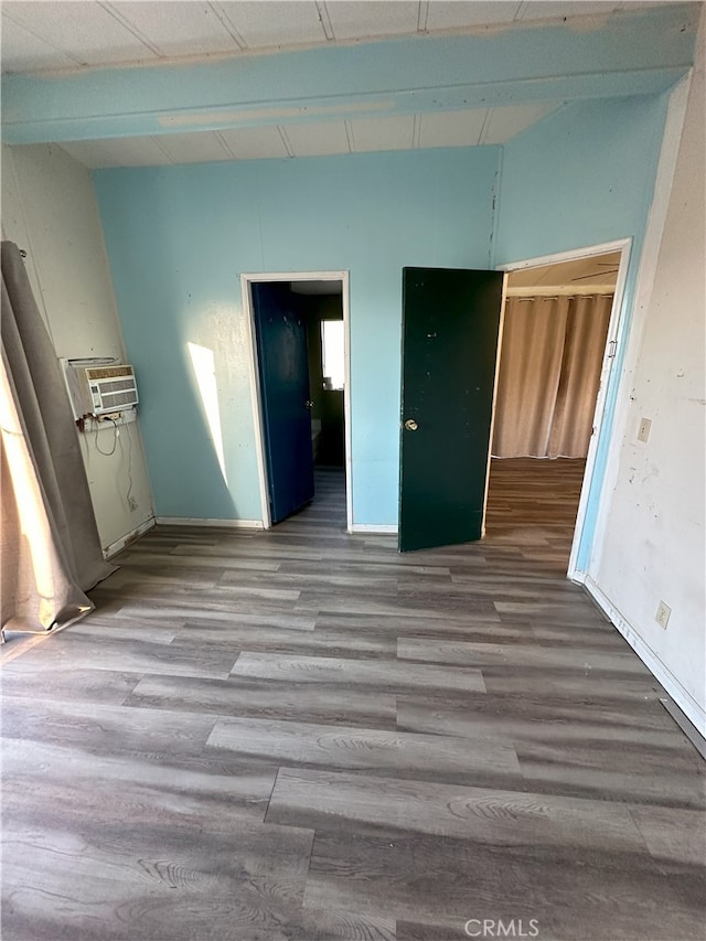7677 Bedouin Ave Unit 29, Palms, CA 92277 - unfurnished room featuring wood finished floors and an AC wall unit