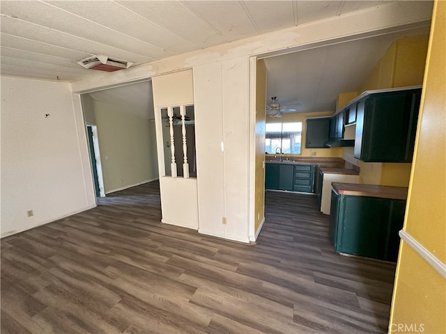 7677 Bedouin Ave Unit 29, Palms, CA 92277 - kitchen with dark wood-type flooring, stove, open floor plan, blue cabinetry, and a ceiling fan