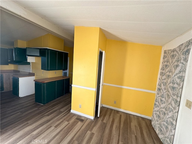 7677 Bedouin Ave Unit 29, Palms, CA 92277 - kitchen featuring wood finished floors, vaulted ceiling, and baseboards