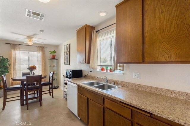 28001 Winged Foot Dr, Menifee, CA 92586 - kitchen featuring a sink, white dishwasher, black microwave, brown cabinets, and a ceiling fan