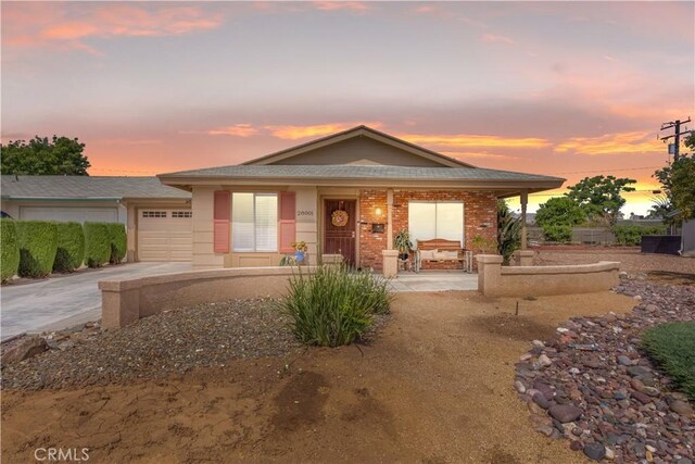 28001 Winged Foot Dr, Menifee, CA 92586 - view of front of house featuring a porch, an attached garage, driveway, and roof with shingles