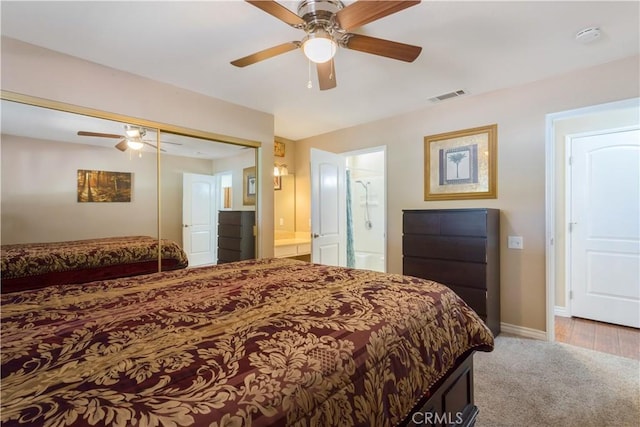 28001 Winged Foot Dr, Menifee, CA 92586 - bedroom with carpet floors, baseboards, a closet, ensuite bath, and ceiling fan
