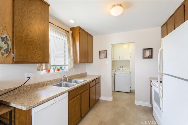 28001 Winged Foot Dr, Menifee, CA 92586 - kitchen with white appliances, a sink, washer and dryer, baseboards, and brown cabinets