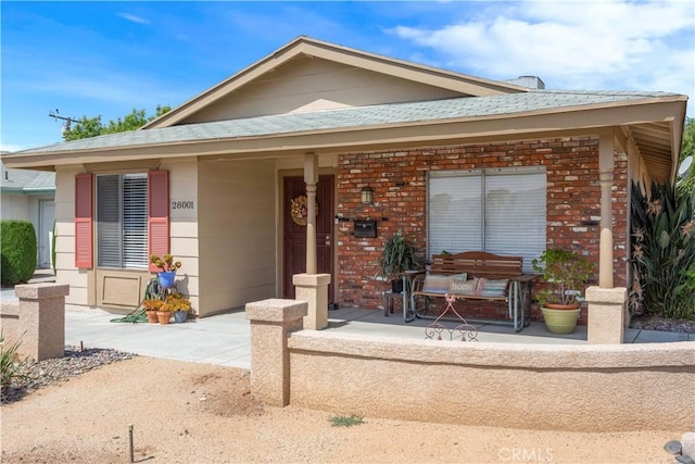 28001 Winged Foot Dr, Menifee, CA 92586 - view of front facade with brick siding and covered porch