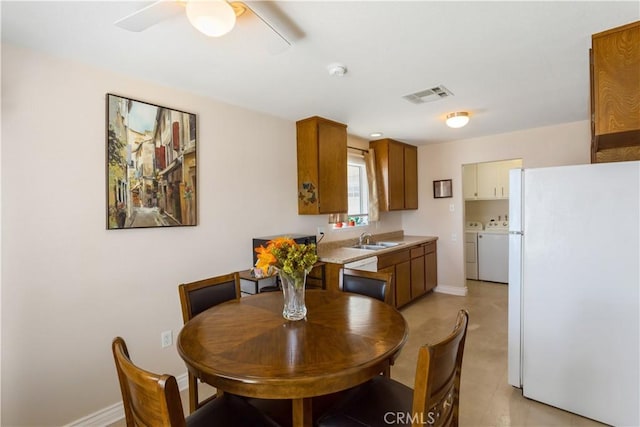 28001 Winged Foot Dr, Menifee, CA 92586 - dining area featuring washer and dryer, ceiling fan, and baseboards