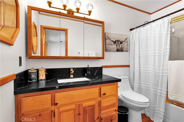 bathroom featuring ornamental molding, vanity, toilet, wood finished floors, and shower / bath combination with curtain