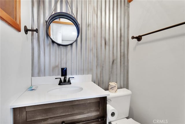 bathroom with toilet and vanity