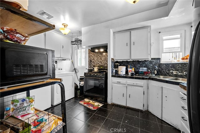 1022 W 101st St, Los Angeles, CA 90044 - kitchen featuring black appliances, washer / dryer, tile counters, white cabinetry, and decorative backsplash