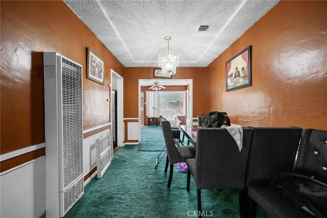 1022 W 101st St, Los Angeles, CA 90044 - carpeted dining area with a heating unit, a textured ceiling, and a chandelier