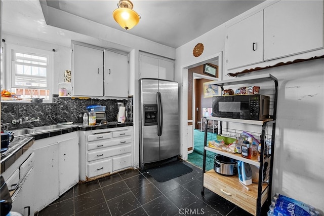 1022 W 101st St, Los Angeles, CA 90044 - kitchen featuring stainless steel fridge, black microwave, tile countertops, and white cabinetry