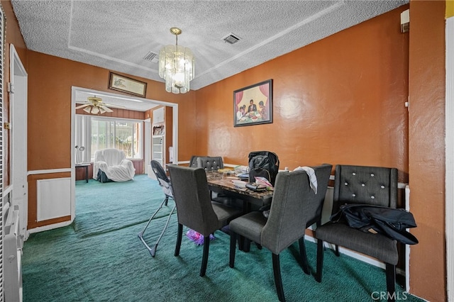 1022 W 101st St, Los Angeles, CA 90044 - carpeted dining space with a chandelier, a textured ceiling, and a textured wall