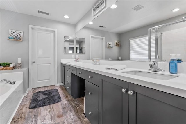 3039 Cayenne Way, Perris, CA 92571 - full bath with a bath, a shower stall, double vanity, recessed lighting, and wood finished floors