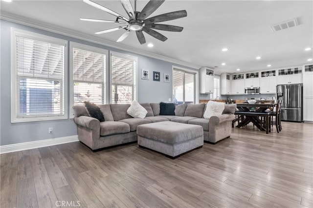 3039 Cayenne Way, Perris, CA 92571 - living area featuring crown molding, ceiling fan, wood finished floors, recessed lighting, and baseboards