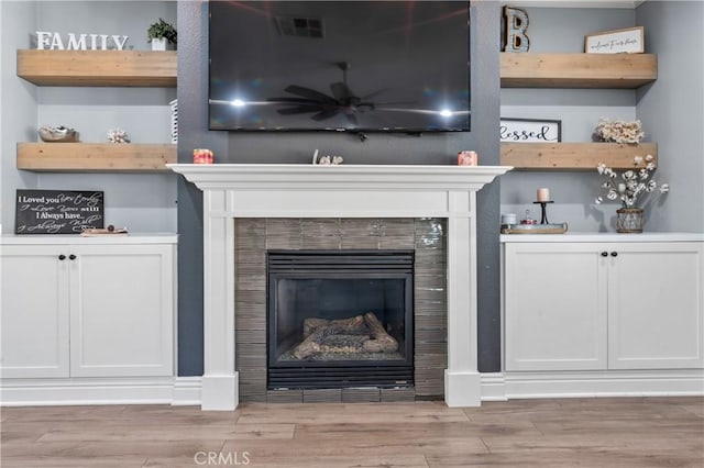 3039 Cayenne Way, Perris, CA 92571 - detailed view of a fireplace, wood finished floors, and ceiling fan