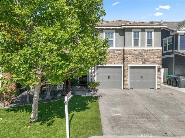 3039 Cayenne Way, Perris, CA 92571 - view of front of home featuring concrete driveway, stucco siding, stone siding, an attached garage, and a front yard