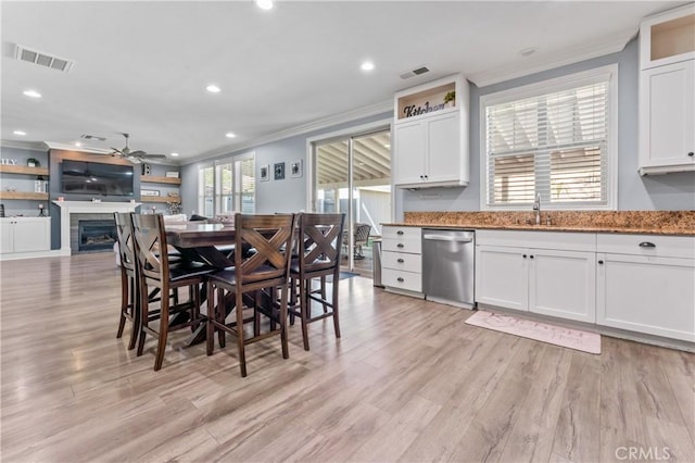 3039 Cayenne Way, Perris, CA 92571 - dining area featuring crown molding, a ceiling fan, light wood-style floors, recessed lighting, and a glass covered fireplace