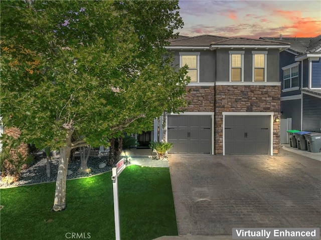 3039 Cayenne Way, Perris, CA 92571 - view of front of house with driveway, stone siding, an attached garage, a lawn, and stucco siding