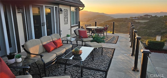 26780 Camino Seco, Temecula, CA 92590 - patio terrace at dusk featuring outdoor lounge area, a mountain view, outdoor dining space, and a patio