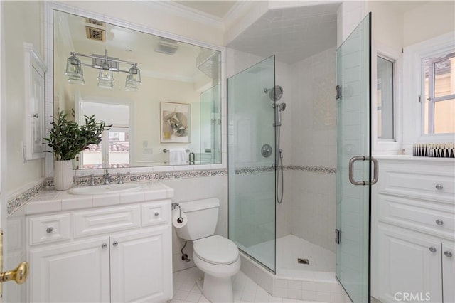 24352 Santa Clara Ave, Dana Point, CA 92629 - bathroom featuring ornamental molding, plenty of natural light, a shower stall, vanity, and tile walls