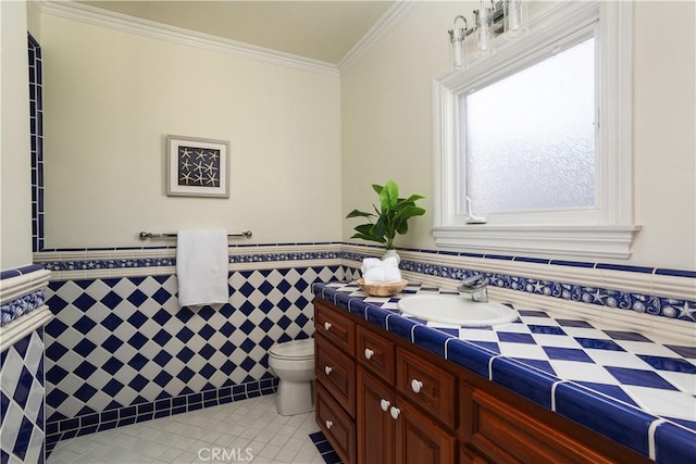 24352 Santa Clara Ave, Dana Point, CA 92629 - bathroom with tile patterned floors, tile walls, vanity, crown molding, and a wainscoted wall