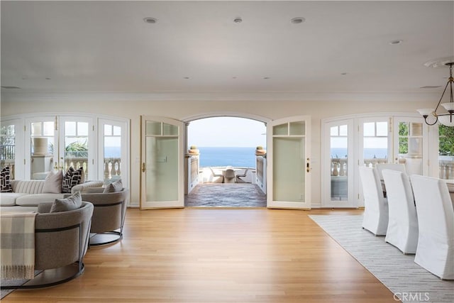 24352 Santa Clara Ave, Dana Point, CA 92629 - living room with ornamental molding, light wood-style floors, a chandelier, and a water view