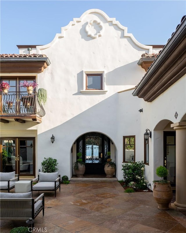 24352 Santa Clara Ave, Dana Point, CA 92629 - back of house with stucco siding, french doors, a balcony, a patio area, and an outdoor hangout area