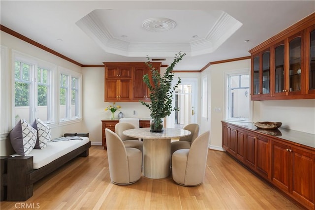 24352 Santa Clara Ave, Dana Point, CA 92629 - dining area with a raised ceiling, light wood-style floors, and crown molding
