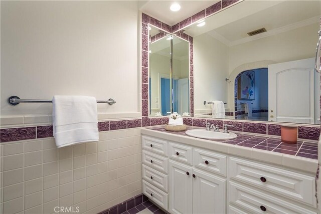 24352 Santa Clara Ave, Dana Point, CA 92629 - bathroom with vanity, crown molding, tile walls, a wainscoted wall, and recessed lighting