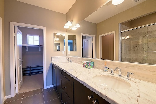 2303 Jefferson St Unit 1215, Torrance, CA 90501 - full bathroom featuring a stall shower, double vanity, baseboards, tile patterned flooring, and a walk in closet