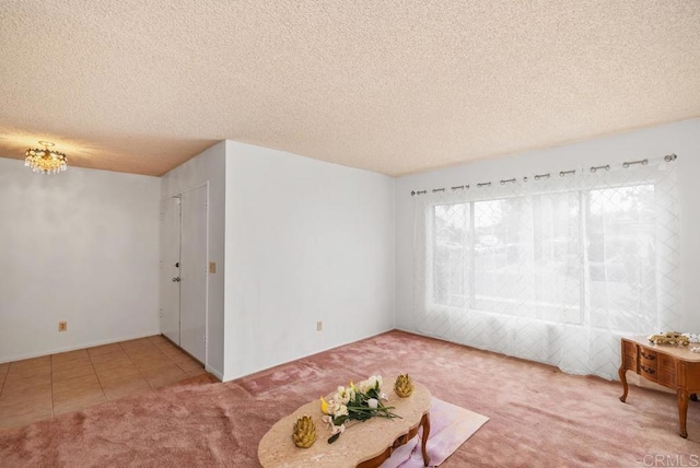 unfurnished living room featuring carpet flooring, a textured ceiling, a chandelier, and tile patterned floors