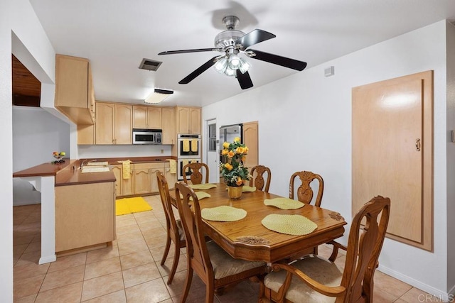 dining area featuring light tile patterned floors and ceiling fan