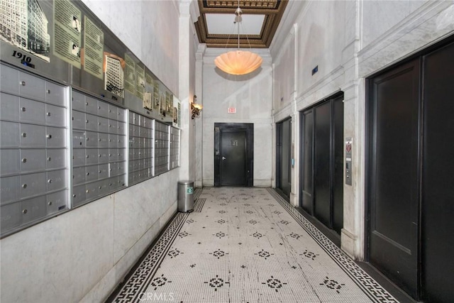 108 W 2nd St Unit 610, Los Angeles, CA 90012 - corridor with a towering ceiling, elevator, mail area, and crown molding