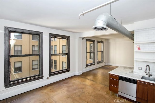 108 W 2nd St Unit 610, Los Angeles, CA 90012 - kitchen featuring stainless steel dishwasher, a sink, light countertops, baseboards, and tasteful backsplash