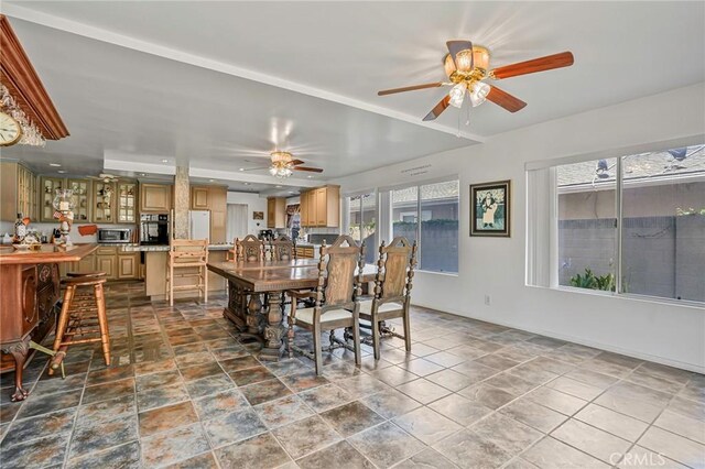 9522 Yellowstone Dr, Huntington Beach, CA 92646 - dining room featuring ceiling fan, plenty of natural light, and dark stone finish floors