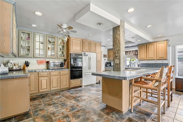 9522 Yellowstone Dr, Huntington Beach, CA 92646 - kitchen with appliances with stainless steel finishes, healthy amount of natural light, a breakfast bar, a ceiling fan, and recessed lighting