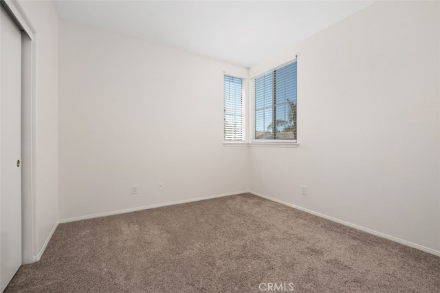 8542 E Heatherview Ln, Orange, CA 92869 - spare room featuring carpet flooring and baseboards