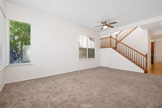 8542 E Heatherview Ln, Orange, CA 92869 - unfurnished living room featuring carpet floors, ceiling fan, stairway, and baseboards