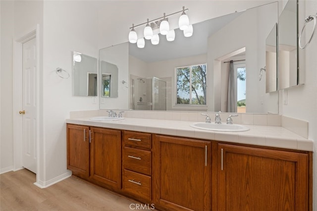 8542 E Heatherview Ln, Orange, CA 92869 - bathroom featuring a shower stall, double vanity, and wood finished floors
