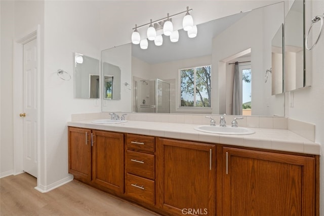 8542 E Heatherview Ln, Orange, CA 92869 - full bath featuring a stall shower, double vanity, and wood finished floors