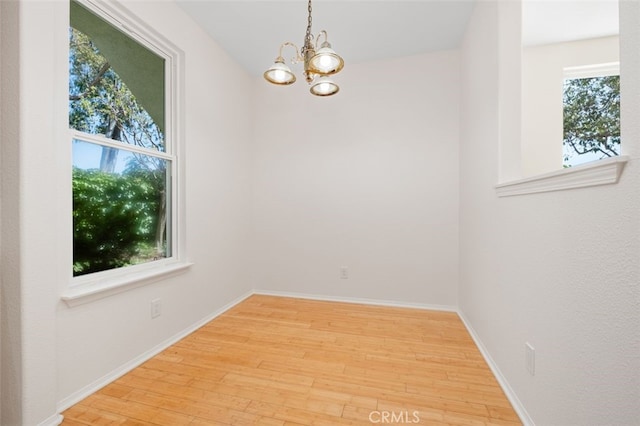 8542 E Heatherview Ln, Orange, CA 92869 - empty room featuring wood finished floors, a chandelier, and baseboards
