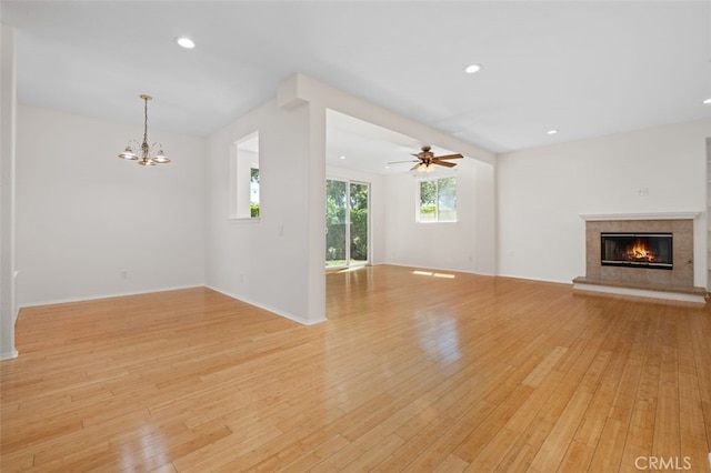 8542 E Heatherview Ln, Orange, CA 92869 - unfurnished living room featuring a tile fireplace, light wood-style floors, a chandelier, recessed lighting, and a ceiling fan