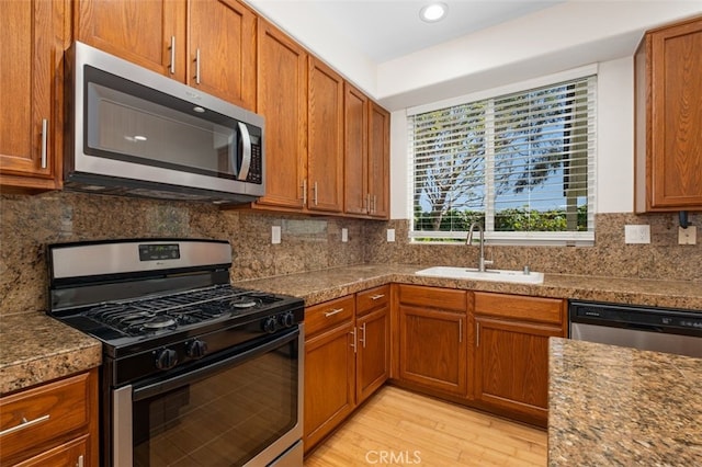 8542 E Heatherview Ln, Orange, CA 92869 - kitchen with appliances with stainless steel finishes, light wood finished floors, brown cabinets, and recessed lighting