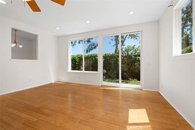8542 E Heatherview Ln, Orange, CA 92869 - empty room with healthy amount of natural light, light wood finished floors, a ceiling fan, and recessed lighting