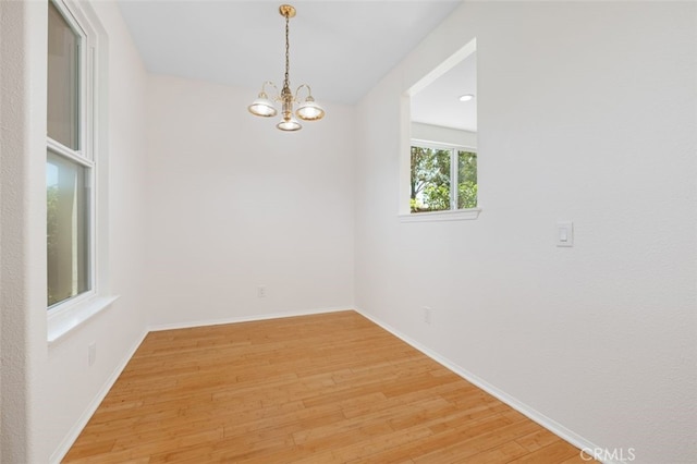 8542 E Heatherview Ln, Orange, CA 92869 - unfurnished room with light wood-type flooring, a chandelier, and baseboards